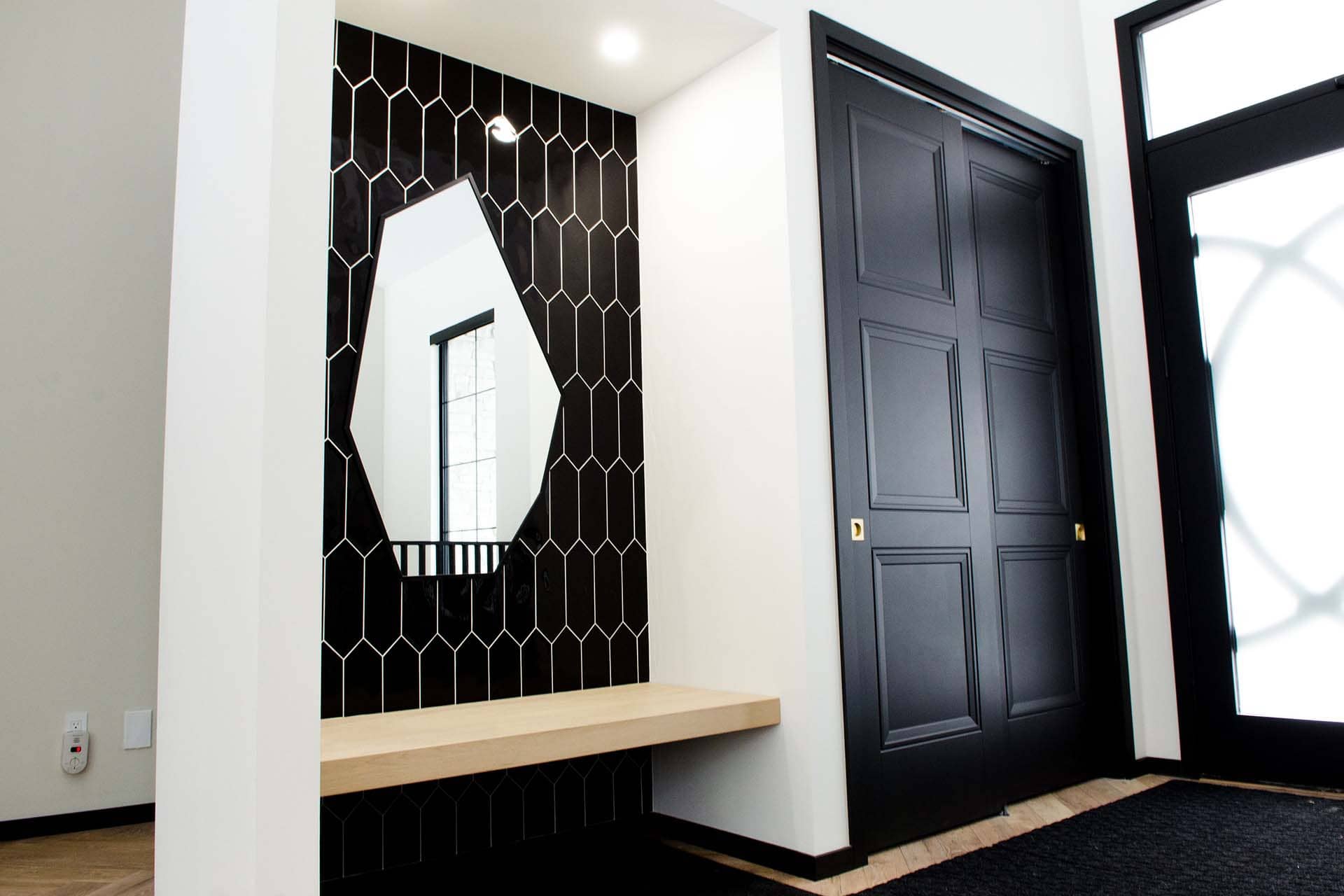 home hallway with black picket pattern tiles and mirror designed and installed by The Tile Centre, Brandon Manitoba MB